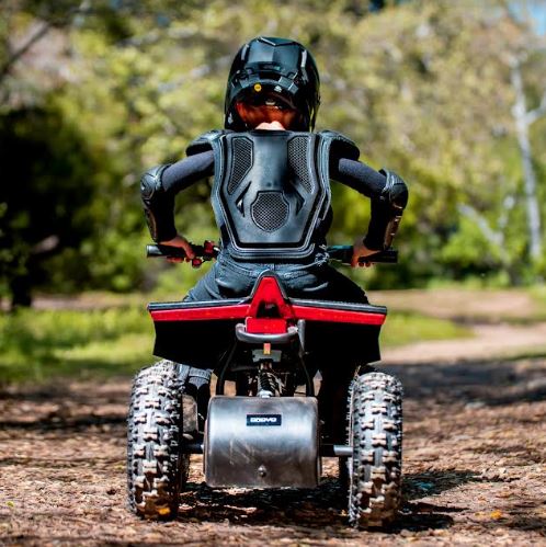 Child riding ATV on trail